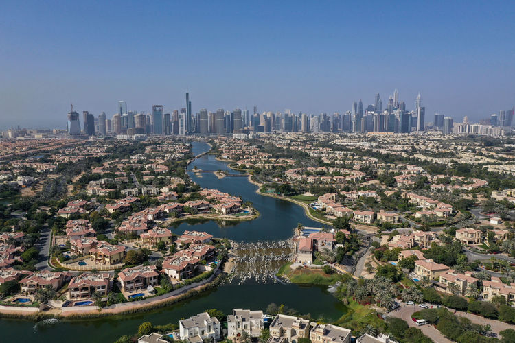 Drone shot of jumeirah islandisla and dubai marina in a far background. united arab emirates.