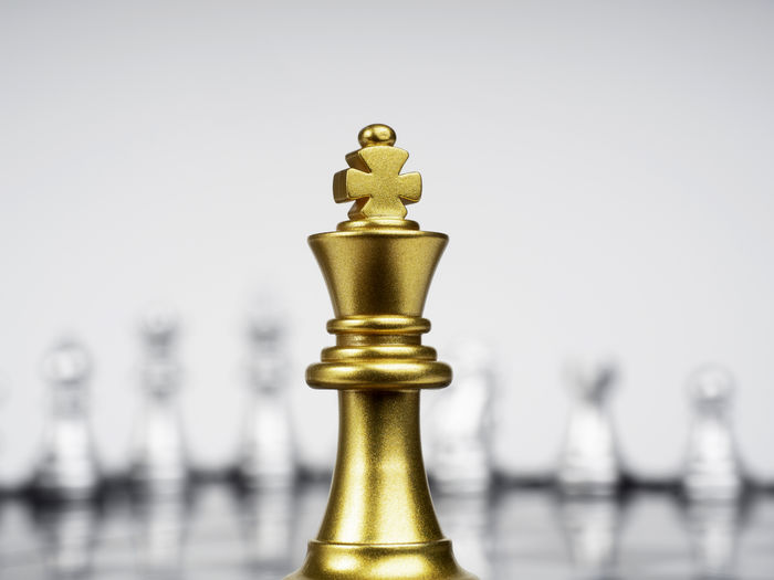 Close-up of chess pieces against clear sky
