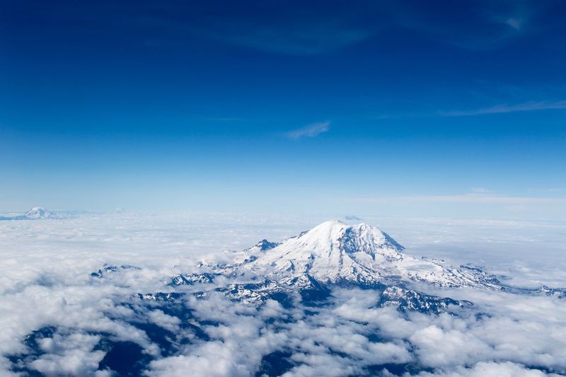 Scenic view of snowcapped mountains against blue sky