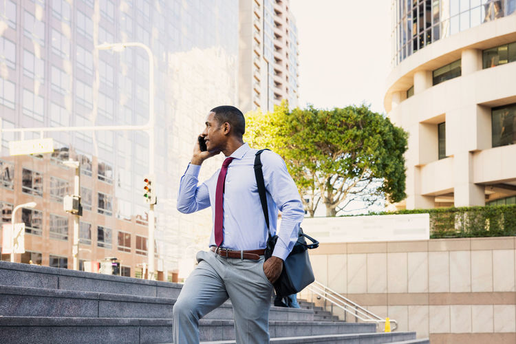 Young man standing against buildings