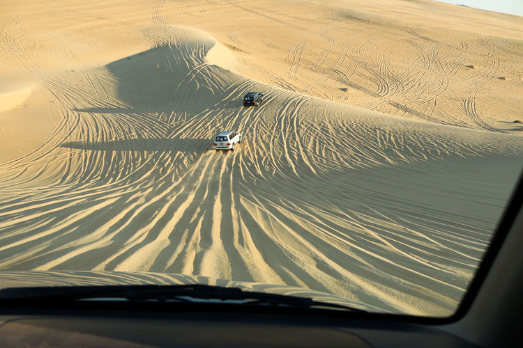 Tilt image of car on desert land