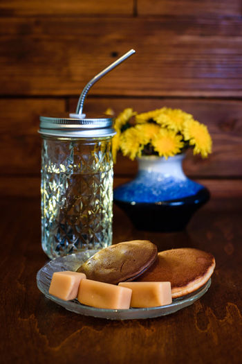 Close-up of a drink in a glass jar on the table, pancakes