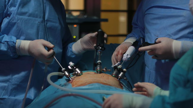 Midsection of doctors operating patient during surgery