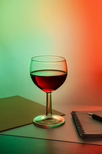Close-up of wineglass on table against wall