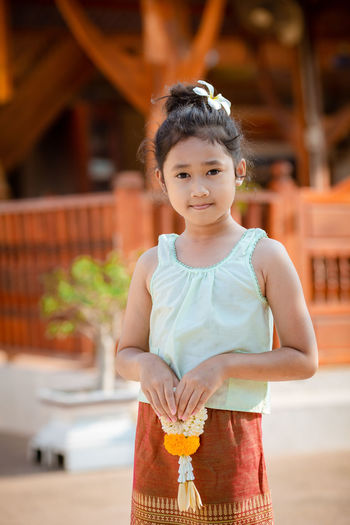 Portrait of cute girl standing outdoors