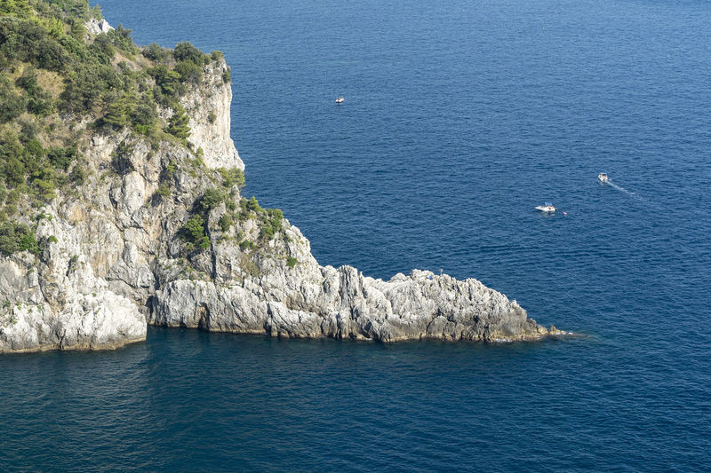 High angle view of rocks by sea