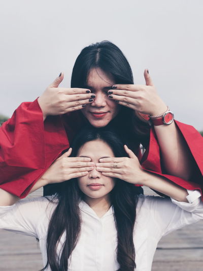 Portrait of women covering eyes