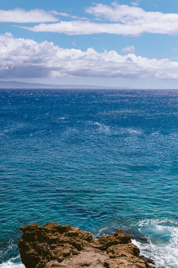 Scenic view of sea against cloudy sky