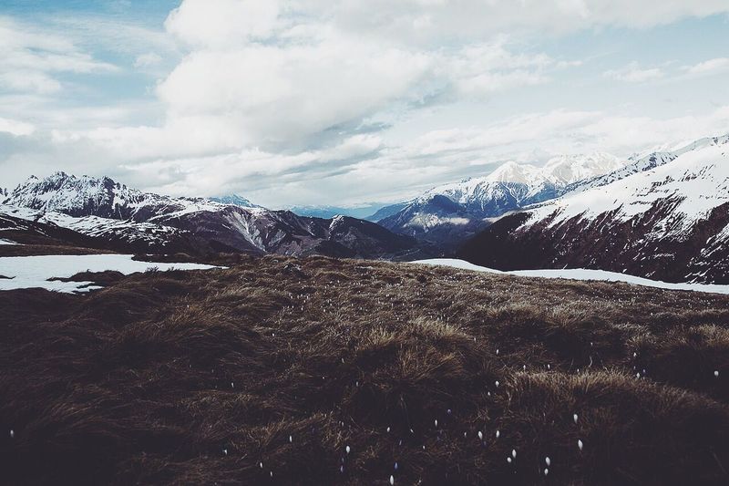 Scenic view of snow covered mountains against sky