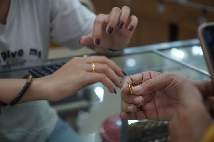 Women trade gold at jewelry stores