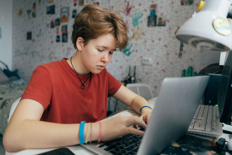 Boy using laptop at home