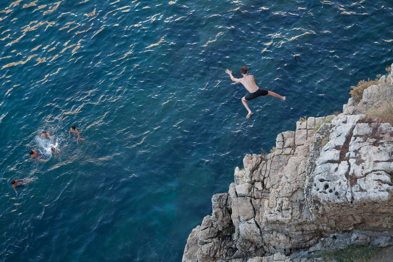 High angle view of man jumping in sea