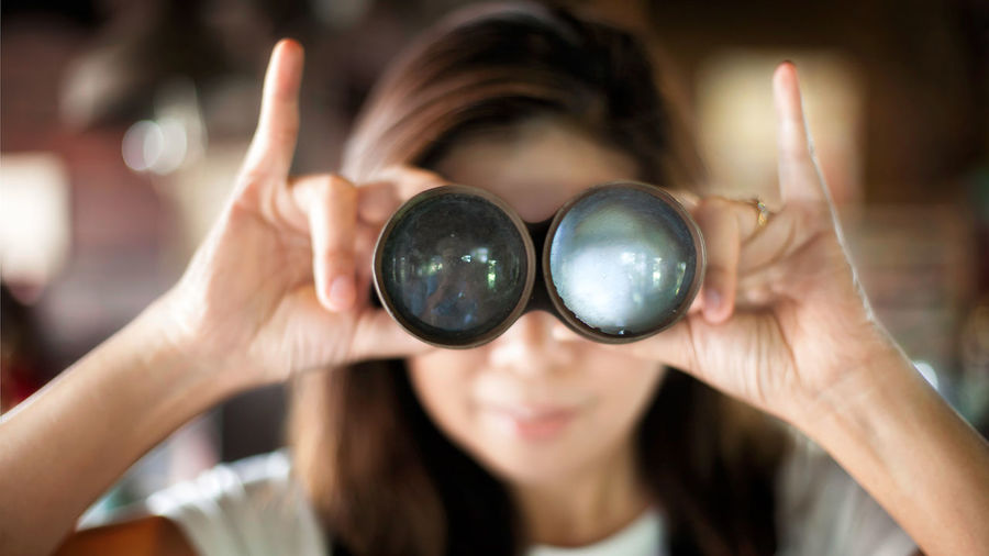 Close-up of a woman looking through binoculars