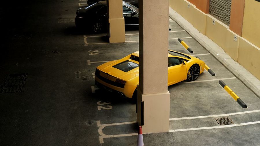 High angle view of yellow car on parking lot