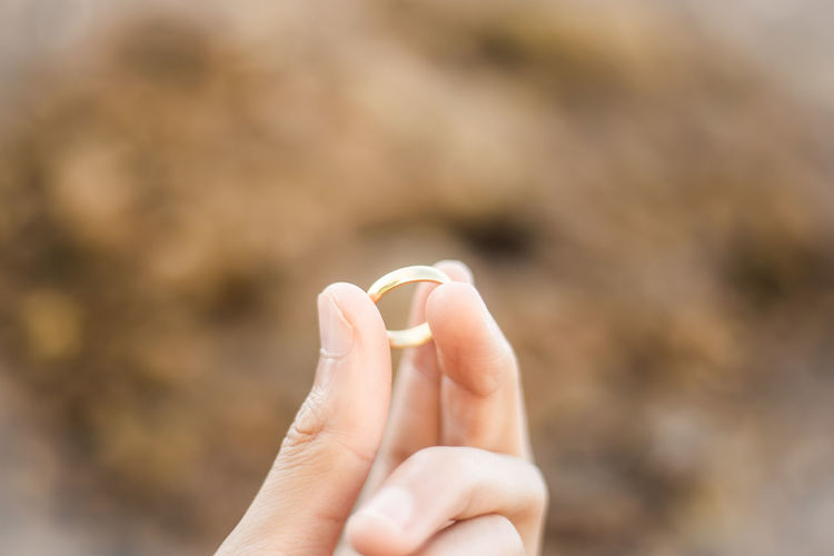 Close-up of cropped woman hand holding ring