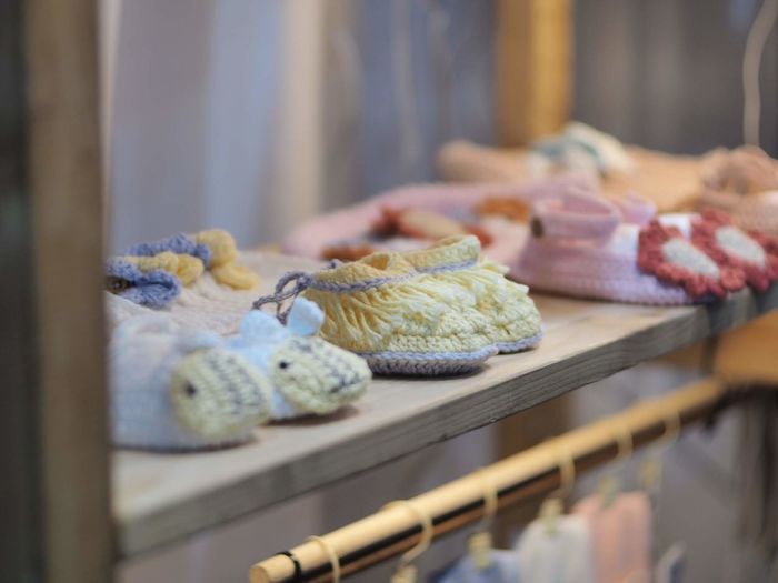 Baby booties on shelf for sale at store