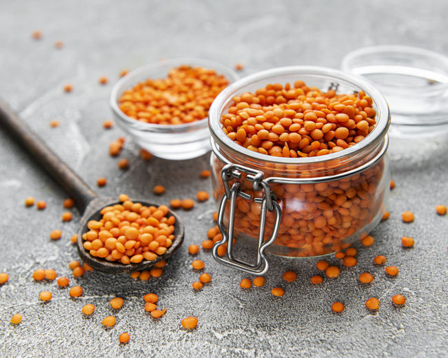 Organic healthy red lentils in glass jar on a table