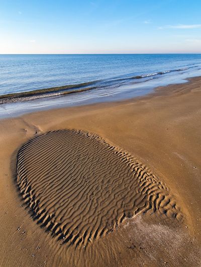 Low tide outflow marks on a sandy beach