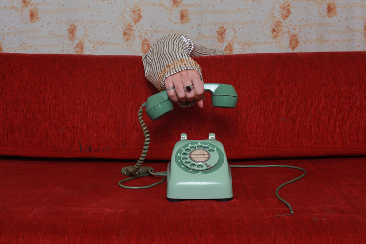 Cropped hand holding telephone receiver