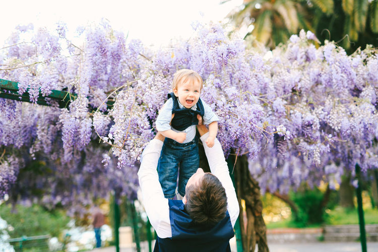 Full length portrait of child on purple flowering plants