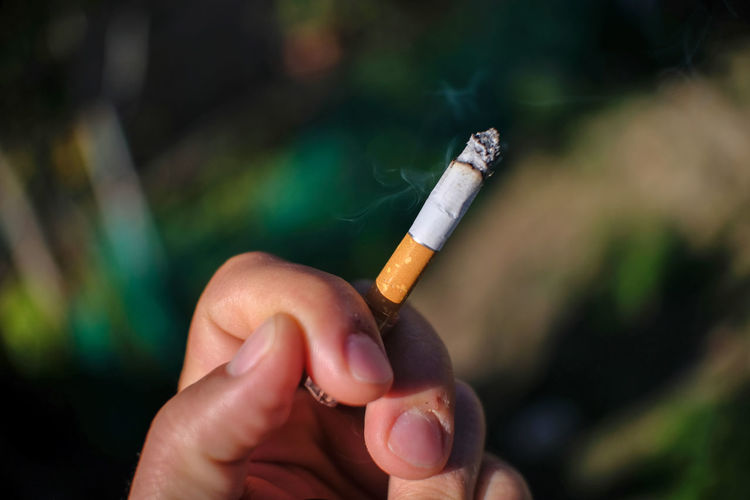 Human hand hold cigarette while smoking,no smoke,people health care