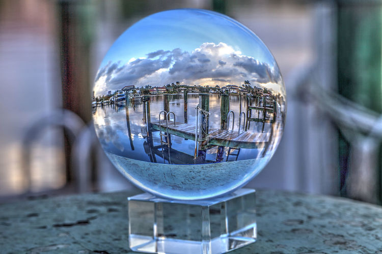 Close-up of crystal ball on glass of building