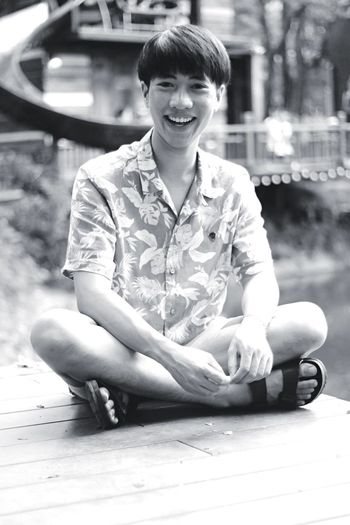 Portrait of smiling young man sitting outdoors