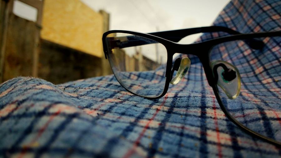 Close-up of eyeglasses on bed