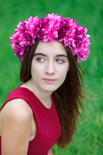 Portrait of beautiful woman with pink flower