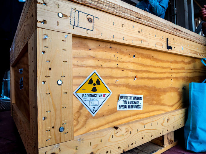 Close-up of warning sign on wooden box