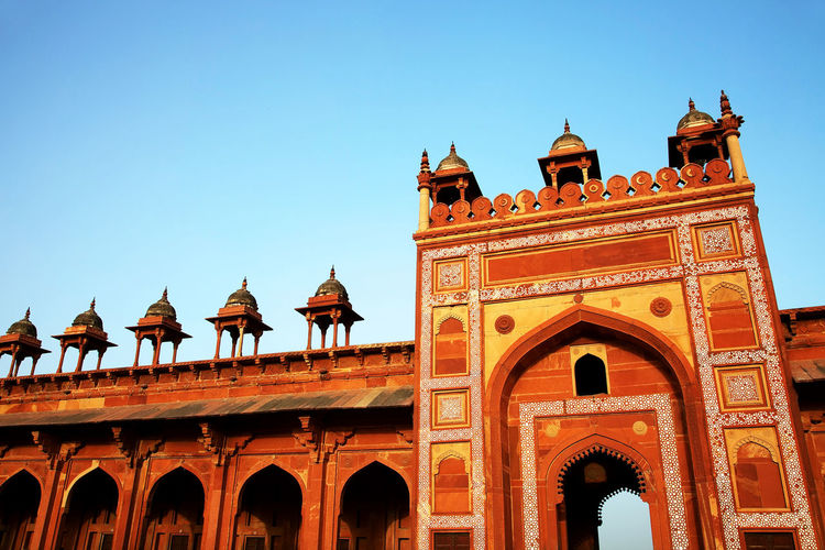 Low angle view of agra fort against clear blue sky