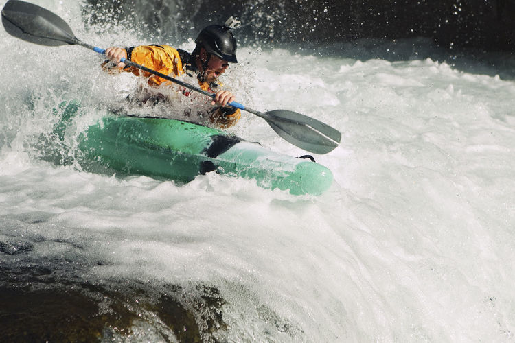 Whitewater kayaker descending waterfall rapids