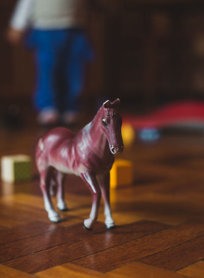 Close-up of toy horse on floor at home