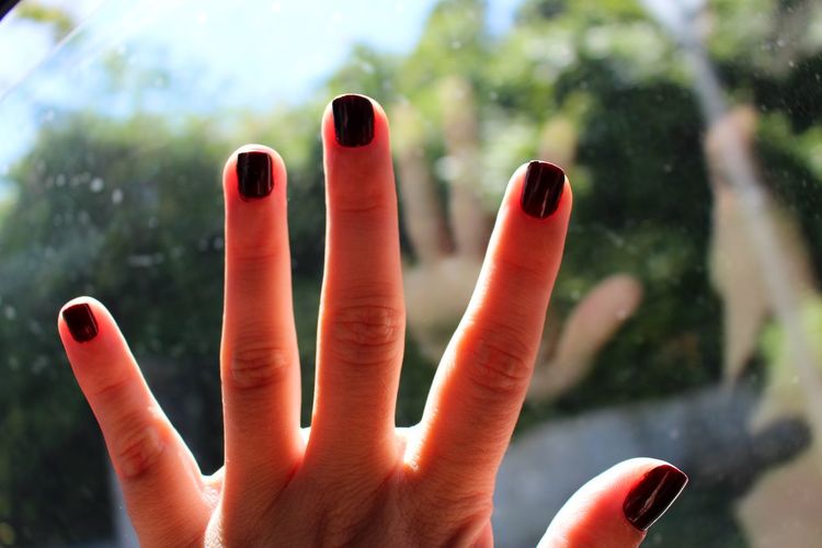 Close-up of human fingers with nail varnish