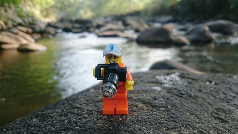 Close-up of toy car on rock by river