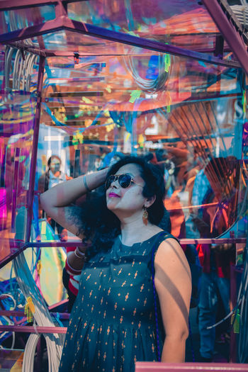 Young woman looking away at amusement park