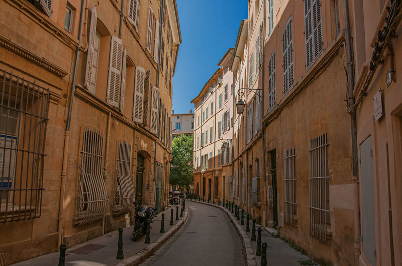 Narrow alley with buildings in the shadow at aix-en-provence, in the french provence.