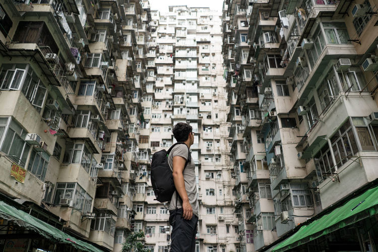 Man standing amidst buildings in city