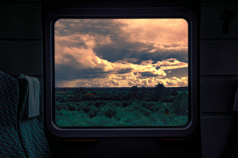 Scenic view of train window against sky