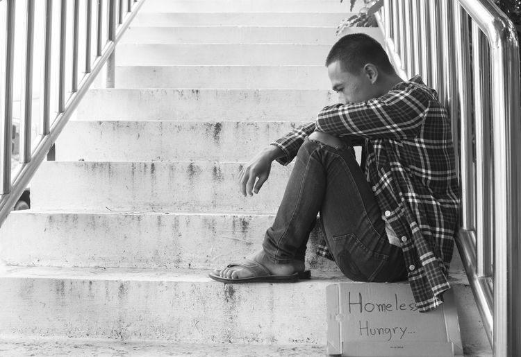 Full length of boy sitting on staircase
