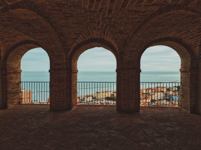 View of sea seen through arch window