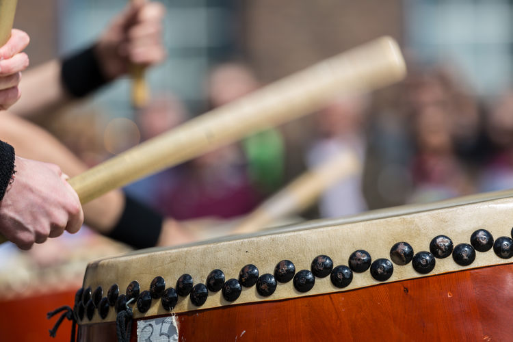 Close-up of man banging drum