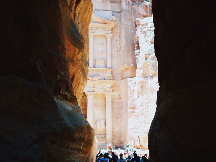 People amidst rock formations at petra