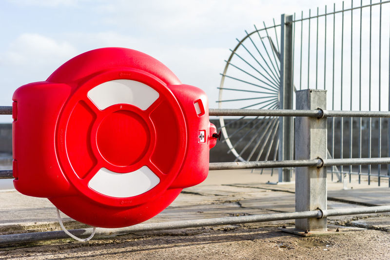 Close-up of red wheel against built structure