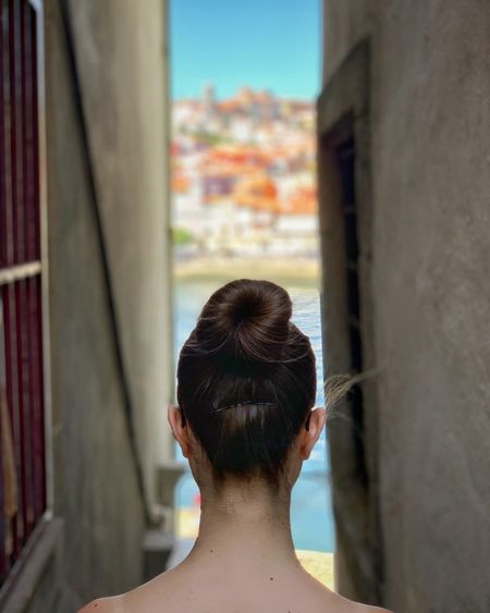 Rear view of woman against wall