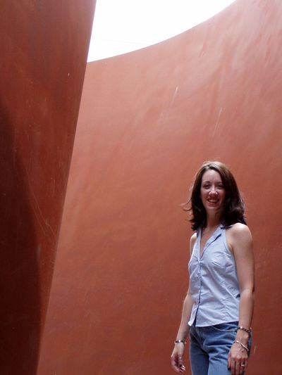 Portrait of mature woman standing against wall