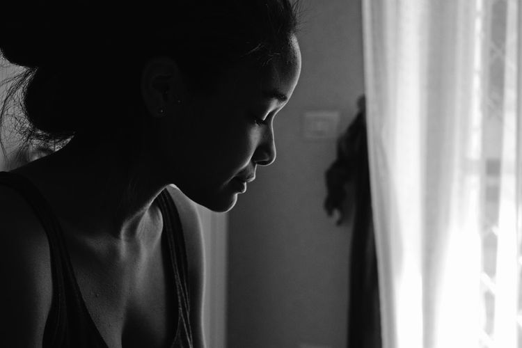 Close-up of depressed young woman at home