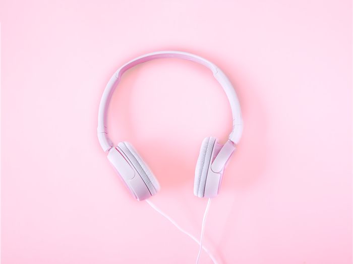 High angle view of headphones against pink background