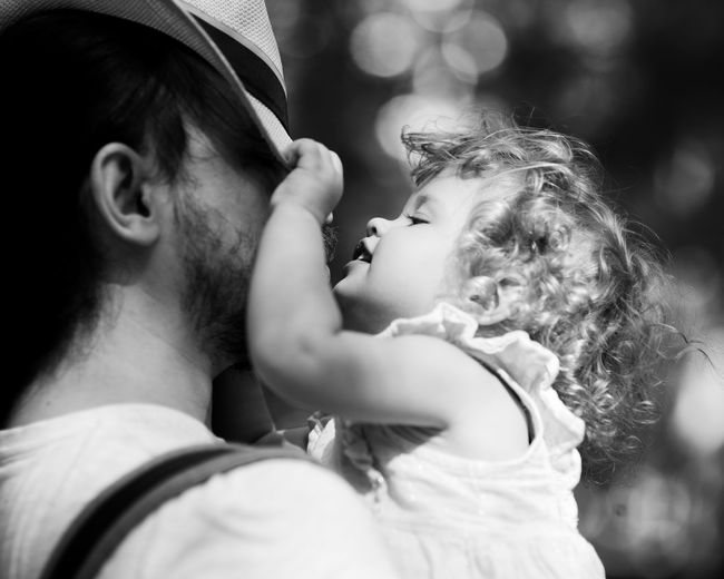 Close-up of father embracing daughter outdoors