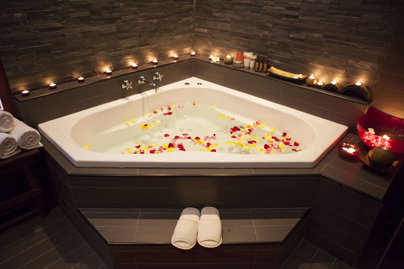 High angle view of petals floating on water in bathtub